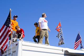 NASCAR fans stand on top of their RV to watch the qualifying rounds at the Las Vegas Motor Speedway, Friday March 9, 2012.